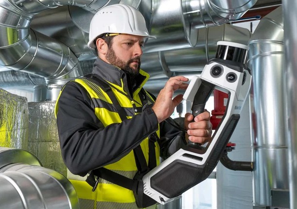 Man in a hard hat using a scanner